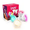 A product shot of a box of Innr smart LED bulbs and several individual bulbs, some lit with different colors. Produktbild-Vorschau