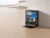 A robotic vacuum cleaner with its docking station, showing internal water tanks. Produktbild-Vorschau