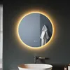 A round LED illuminated mirror above a sink in a modern bathroom. Anteprima dell’immagine prodotto