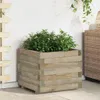 A wooden planter box filled with green plants sits on a tiled patio next to a white wall and a woven cabinet. Náhľad obrázku produktu