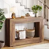 A console table with decorative items and baskets, placed near a staircase. Produktbild-Vorschau