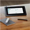 A Wacom graphics tablet is shown on a wooden desk next to a notebook and a stylus. Produktbild-Vorschau