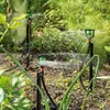 Sprinklers watering plants in a garden. Produktbild-Vorschau
