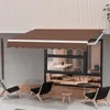 An outdoor seating area with a brown awning over a window, featuring chairs and small tables. Produktbild-Vorschau
