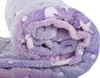 A close-up view of a rolled-up blanket with a star pattern. Náhled obrázku produktu