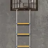 A fire escape ladder is shown hanging against a textured gray wall, extending down from an open window. Náhled obrázku produktu