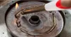 A close-up shot of a metal surface with melted material being heated by a lighter. Náhled obrázku produktu