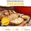 A loaf of bread with a slice cut off, next to a red pot and a small bowl of butter. Voir les images du produit