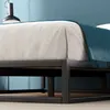 A close-up view of a bed frame with bedding. Produktbild-Vorschau