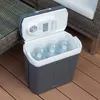An open cooler box filled with water bottles on a wooden deck next to outdoor furniture. Náhľad obrázku produktu