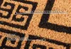 Close-up of a doormat with a geometric pattern and text highlighting its features. Podgląd zdjęcia produktu