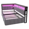 A corner view of a grey upholstered bed frame with a slatted mattress base and integrated LED lighting in pink. Voir les images du produit