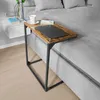 A bedside table with a laptop, cup, and book on a bed. Produktbild-Vorschau