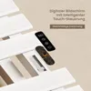 A close-up view of a white electric towel warmer with a remote control and internal circuitry visible. Produktbild-Vorschau