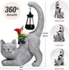 A decorative garden statue of a cat with a gnome riding on its back, holding a lantern. The image includes multiple views and dimensions of the product. Produktbild-Vorschau