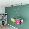 A laundry room with a ceiling-mounted drying rack holding clothes. Anteprima dell’immagine prodotto