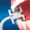 A close-up view of an electric oral irrigator cleaning teeth. Produktbild-Vorschau