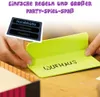 Hands holding game cards and a game board piece with text. Produktbild-Vorschau