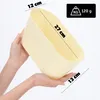 Hands holding a cream-colored oval plastic pot. Produktbild-Vorschau