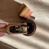 A close-up shot of a hand holding a wooden scoop filled with peppercorns, about to add them to a pepper mill. Náhled obrázku produktu