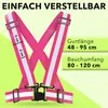 A pink safety vest with reflective stripes, shown against a light green and white background with text overlays indicating dimensions and adjustability. Náhľad obrázku produktu