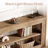 A close-up view of a wooden console table with shelves, displaying decorative items and books. Produktbild-Vorschau