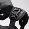 A close-up view of a black snowboard binding buckle and strap. Podgląd zdjęcia produktu