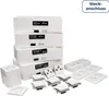 A collection of white boxes containing electrical components, stacked and arranged with loose components in the foreground. Produktbild-Vorschau