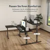 An L-shaped standing desk with two monitors and accessories in a modern office setting. Náhled obrázku produktu