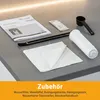An overhead shot of coffee machine accessories laid out on a gray countertop. Produktbild-Vorschau