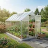 A greenhouse filled with plants in a garden setting. Produktbild-Vorschau
