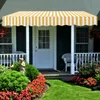 A striped awning over a front door with a porch and garden. Náhled obrázku produktu
