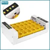 A white automatic egg incubator with yellow egg trays, shown from a diagonal angle. Podgląd zdjęcia produktu