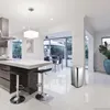 A modern kitchen with a stainless steel trash can placed on a white tiled floor. Produktbild-Vorschau
