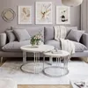 A living room scene with a sofa, coffee tables, and artwork. Náhľad obrázku produktu