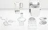 A collection of kitchen appliance attachments and a blender jar are laid out on a white surface. Produktbild-Vorschau