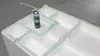 A can of spray foam sits on a white styrofoam structure with green foam sealant applied around the edges. Produktbild-Vorschau