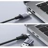 Two close-up shots of a Ugreen USB-C to USB-A adapter cable being connected to a laptop. Náhled obrázku produktu