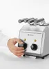 A person's hand is adjusting the dial on a stainless steel toaster. Anteprima dell’immagine prodotto