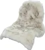 A fluffy, beige and gray faux fur rug is shown against a white background. Produktbild-Vorschau