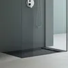 A modern shower tray with a sleek design, featuring a dark gray base and a chrome shower fixture. Produktbild-Vorschau
