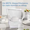 A BRITA water filter pitcher is shown on a table with glasses of water and a salad in the background. Produktbild-Vorschau