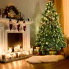 A decorated Christmas tree and fireplace with stockings and candles. Produktbild-Vorschau