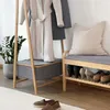A hallway with a coat rack, shoe bench, and shoes. Anteprima dell’immagine prodotto