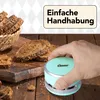 A hand holding a mini vacuum cleaner to clean up crumbs from sliced bread on a wooden table. Anteprima dell’immagine prodotto