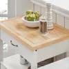 A close-up view of a kitchen cart's wooden countertop, showing decorative items and a drawer. Produktbild-Vorschau