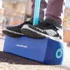 A child's feet wearing sneakers on a blue pogo jumper. Produktbild-Vorschau