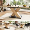 A collage of images showing a wooden extendable dining table with a black base, set in a dining room environment with chairs and decorative items. Anteprima dell’immagine prodotto