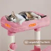 A cat is resting on a pink cat tree perch. Podgląd zdjęcia produktu