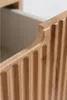 A close-up view of the fluted front of a wooden vanity cabinet. Produktbild-Vorschau